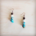 Handcrafted boho drop earrings featuring brown wood, white turquoise, and blue regalite stone beads on copper-tone hooks.