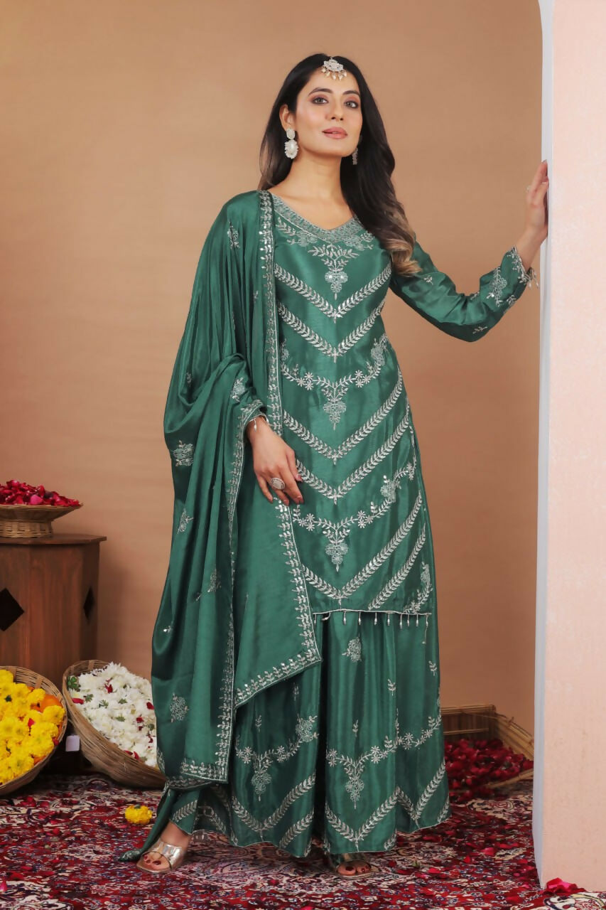 Elegant green silk sharara set with intricate embroidery and a classic kurti