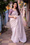 Grey linen saree with self-weaving checks and a luxury golden border detail.