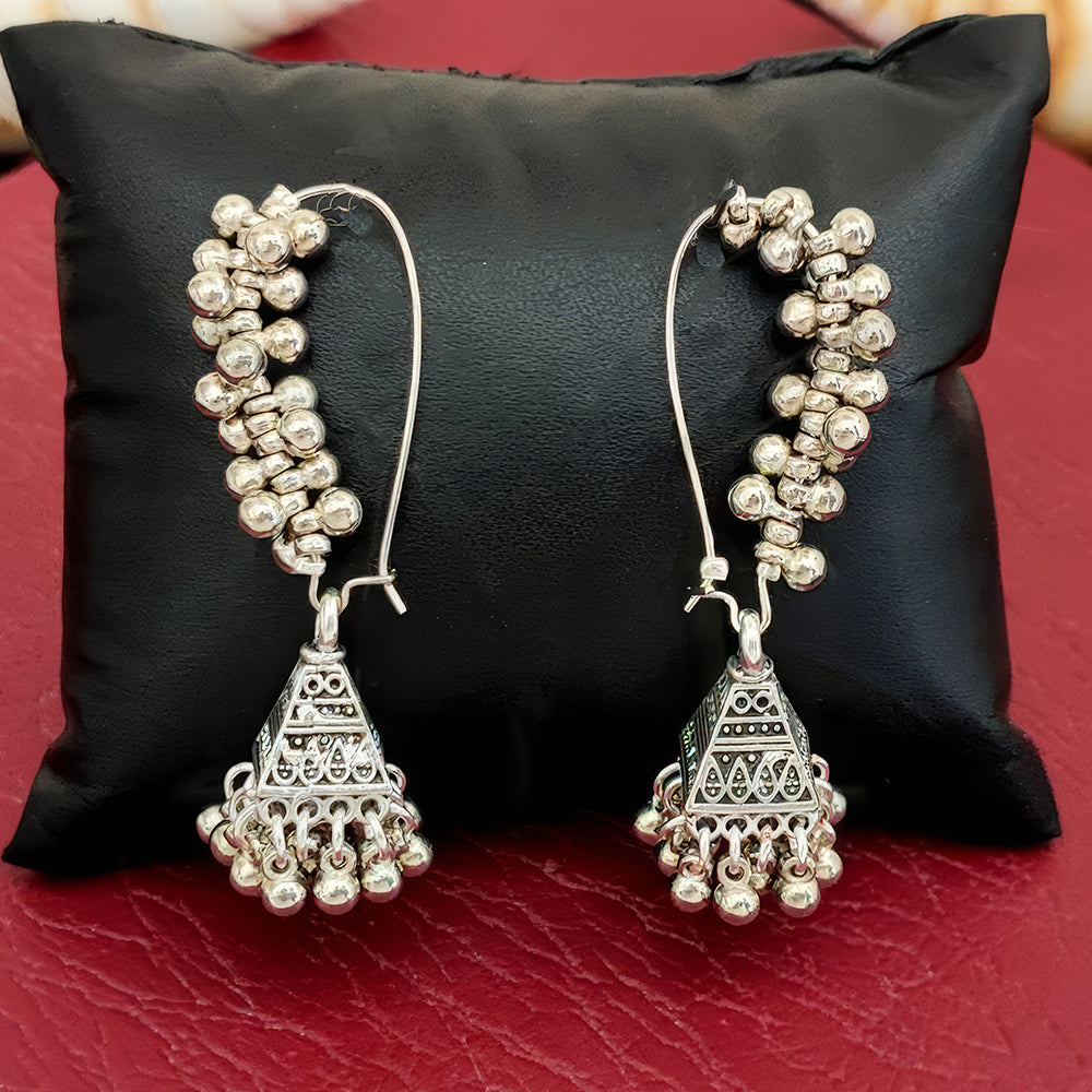 Close-up of fancy antique-style oxidized silver polish earrings for girls