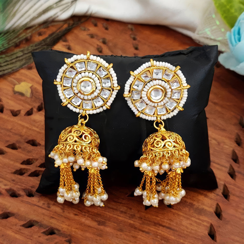 Close-up view of traditional Kundan earrings with a high gold polish finish