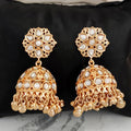 Antique jhumka earrings with high gold polish for a traditional Indian bridal look.