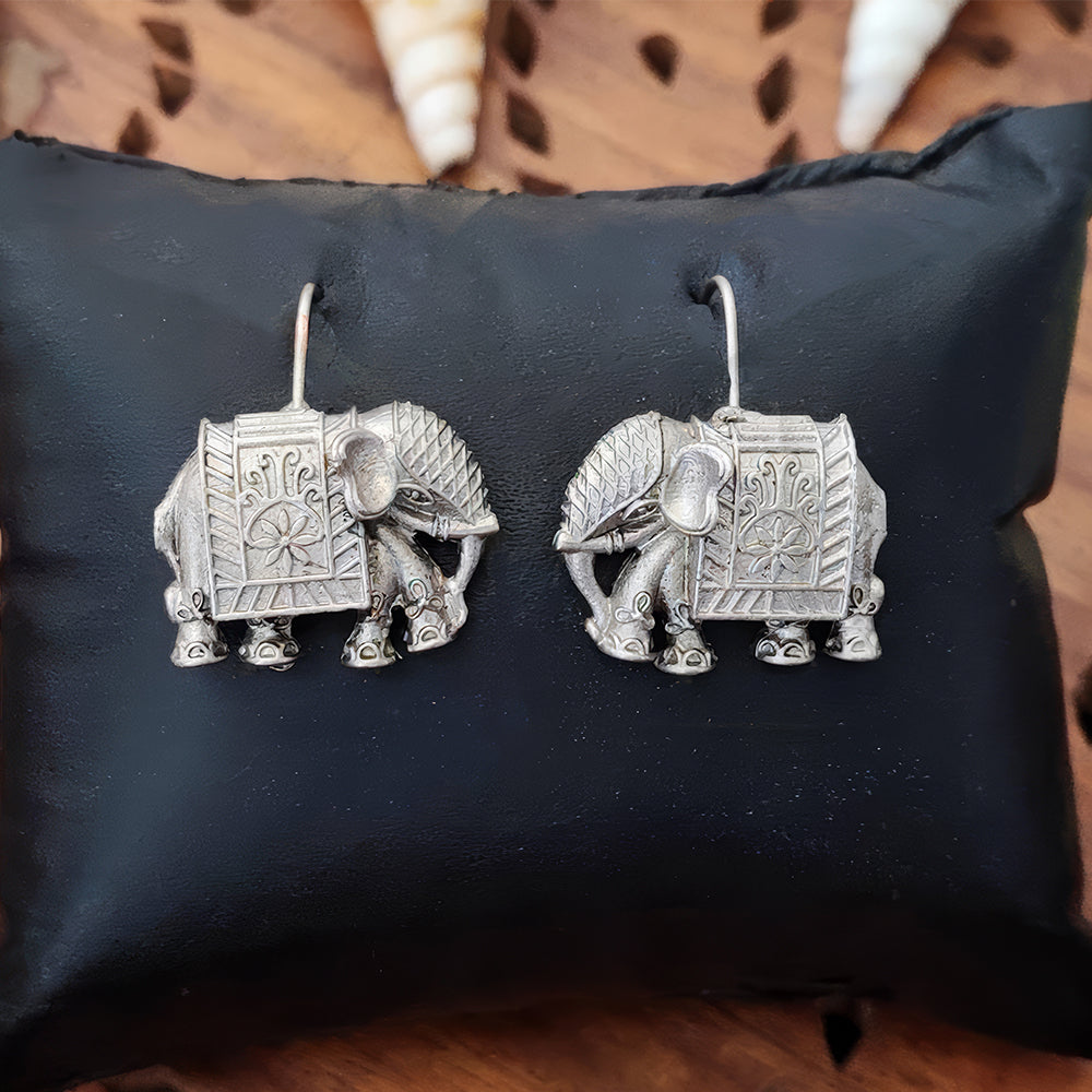 Designer oxidized silver jhumka and dangler earrings for women, featuring intricate ethnic metalwork.