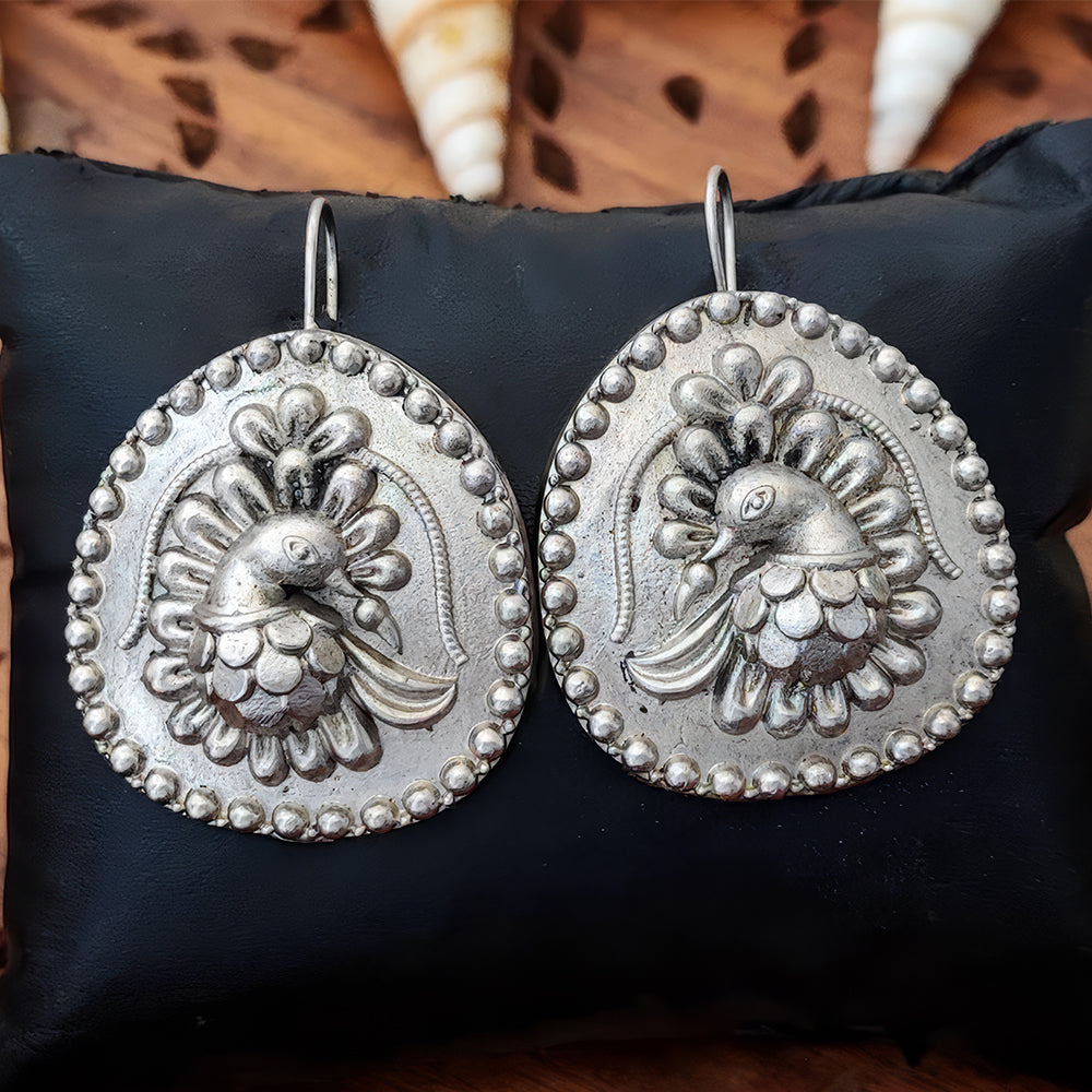 A pair of intricate oxidized silver jhumka style dangle earrings for women and girls