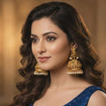 Antique Rajwadi Temple Jhumka earrings with traditional polish and delicate pearl drop accents.