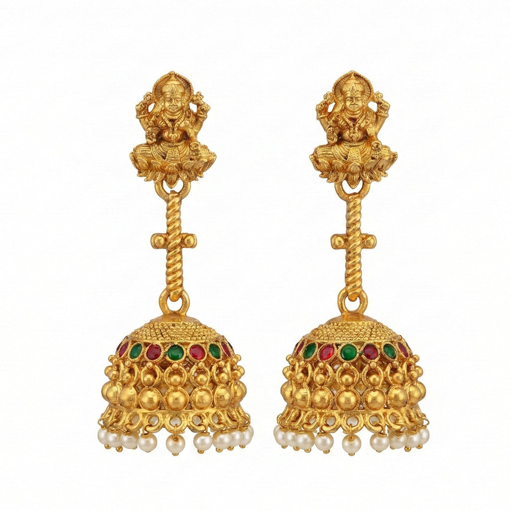 Close up of Traditional Rajwadi gold temple jhumka earrings with intricate carvings.