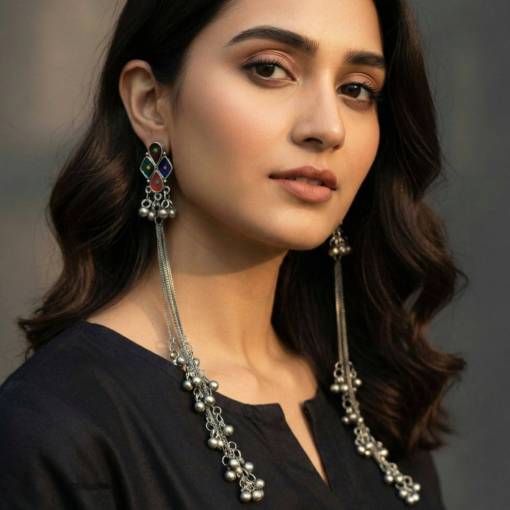 Tribal oxidized long dangler earrings featuring intricate silver-finish motifs and vibrant multicolor stones.
