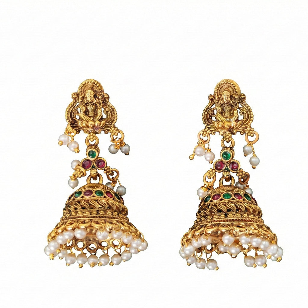 Close up of traditional Rajwadi gold-tone temple jhumka earrings with pearl drops