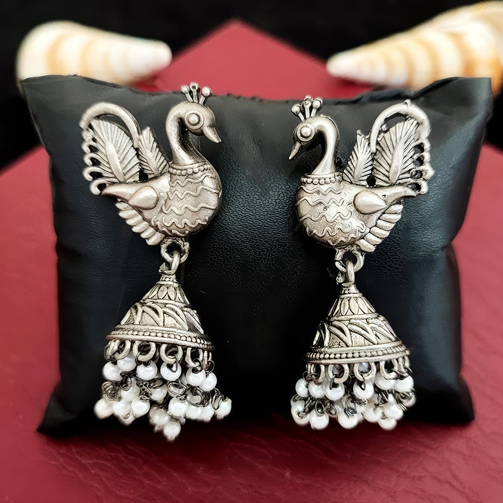 Oxidized silver jhumka earrings featuring intricate peacock design and antique finish