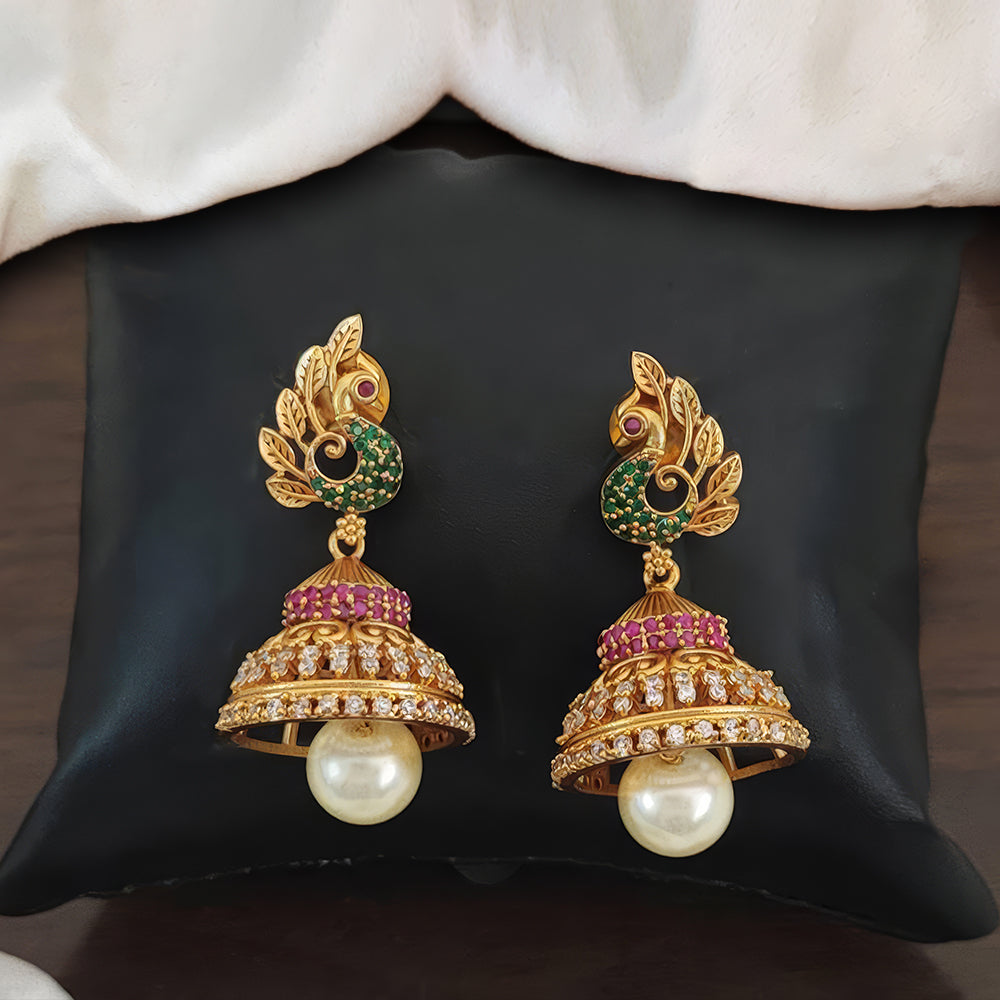 Matte gold peacock design Jhumka earrings with traditional kemp stones