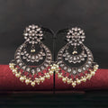 Close-up of gold-toned Chandbali earrings featuring Polki stones and white clustered pearl drops