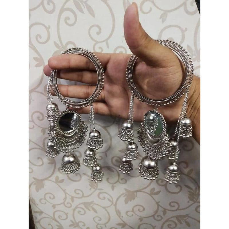 Wide silver bangle decorated with mirrors, jhumkas, and long dangling chains