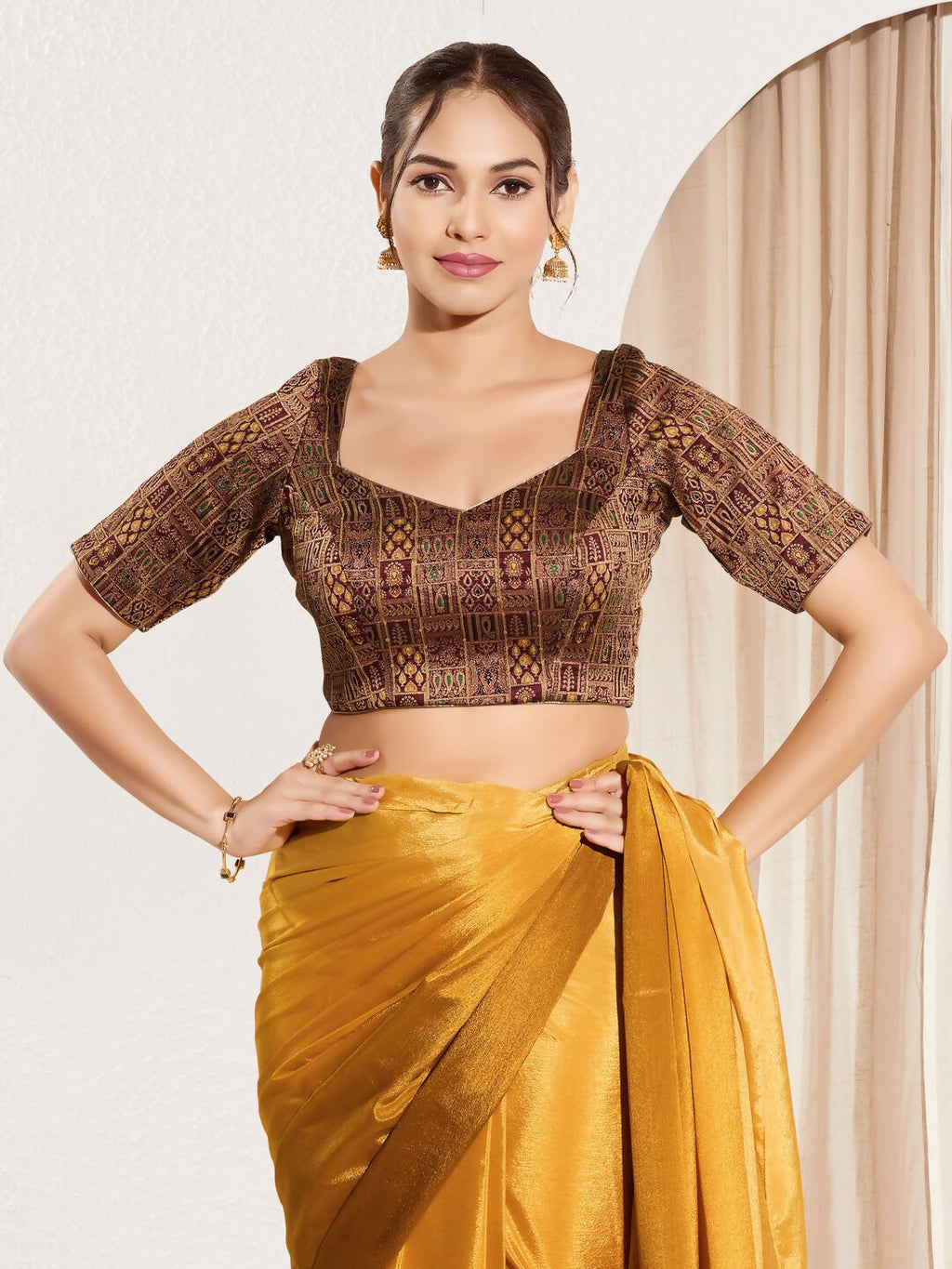 Dark maroon brocade padded blouse with round neck and elbow sleeves