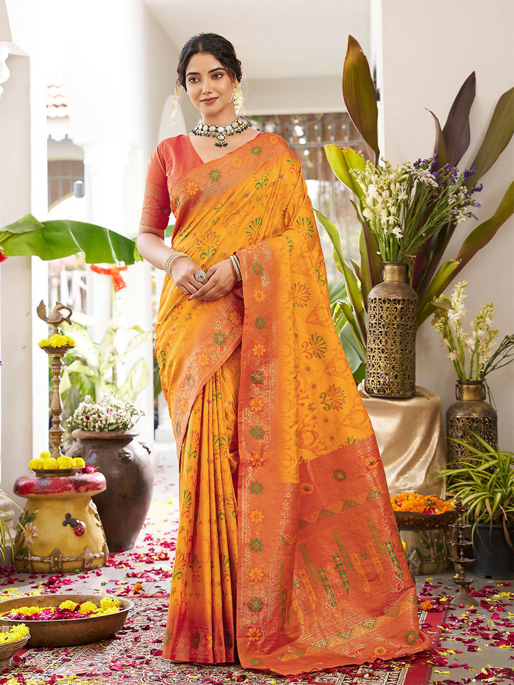 Yellow soft silk saree featuring a contrasting orange blouse piece