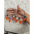 Orange pearl and mirror work bangles with decorative hanging latkans