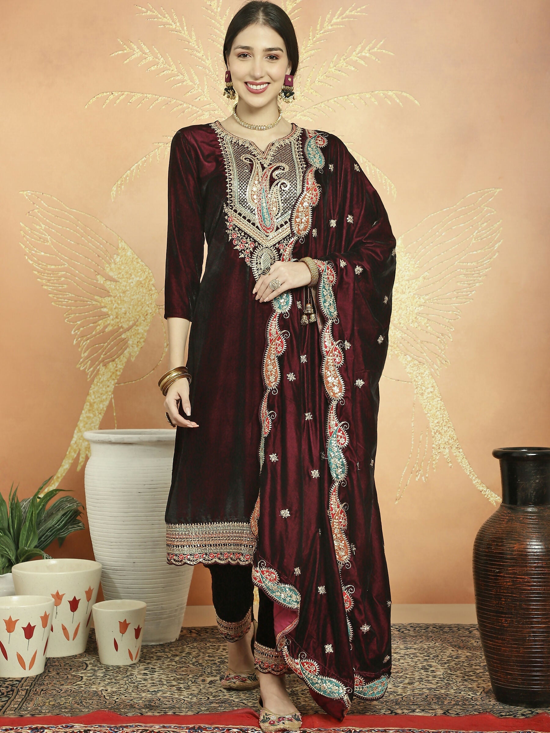 Maroon velvet straight kurta set with cording, Resham thread, and sequin embroidery with matching pants.