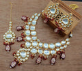 Marron Kundan necklace set with gold plated finish, suitable for traditional outfits.