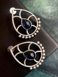 A pair of blue Monalisa stone stud earrings with a polished silver replica finish.
