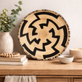 Handcrafted Maze Ugandan basket featuring a black and natural geometric pattern.