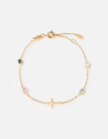 Close up of gold-plated cable chain bracelet with multi-color round crystal bezel accents on a woman's wrist