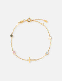 Close up of gold-plated cable chain bracelet with multi-color round crystal bezel accents on a woman's wrist