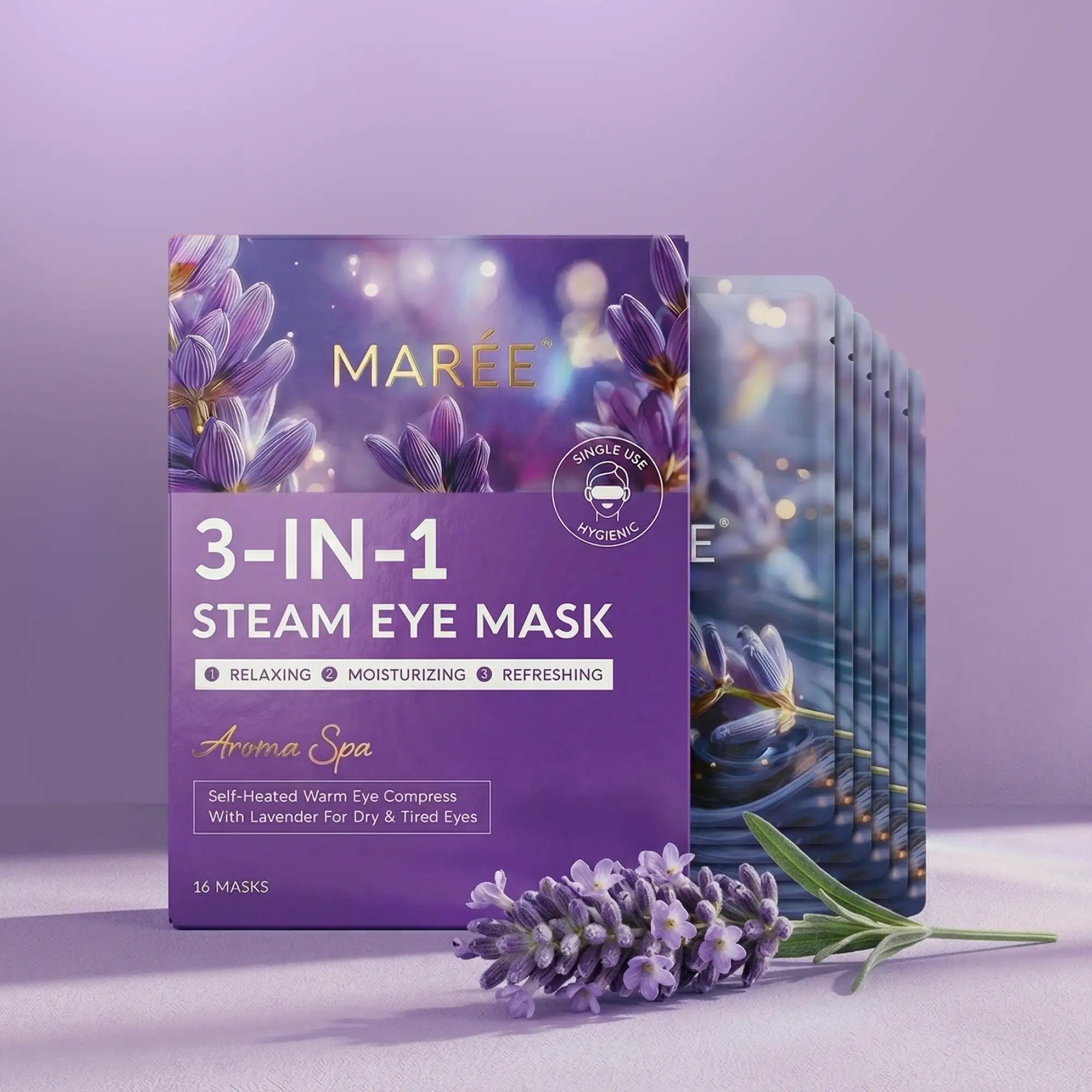A box of Maree 3-in-1 steam eye masks with lavender imagery, featuring individual foil packets and a sprig of fresh lavender flowers.