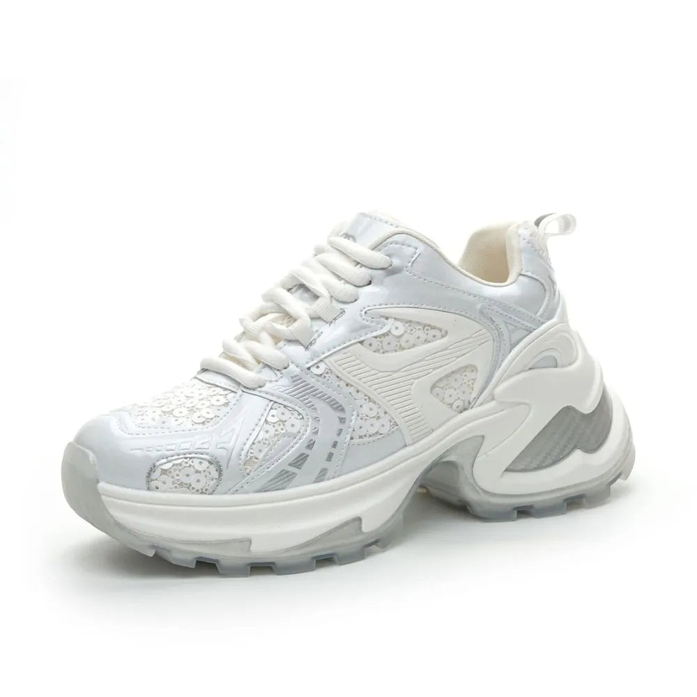 Pair of white and silver sequined platform sneakers with chunky sole and lace-up front on a white background