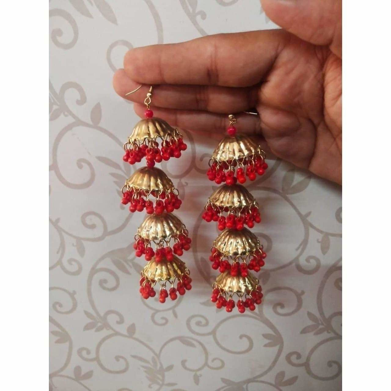 Gold tone latkan jhumka earrings featuring decorative red pearls for girls