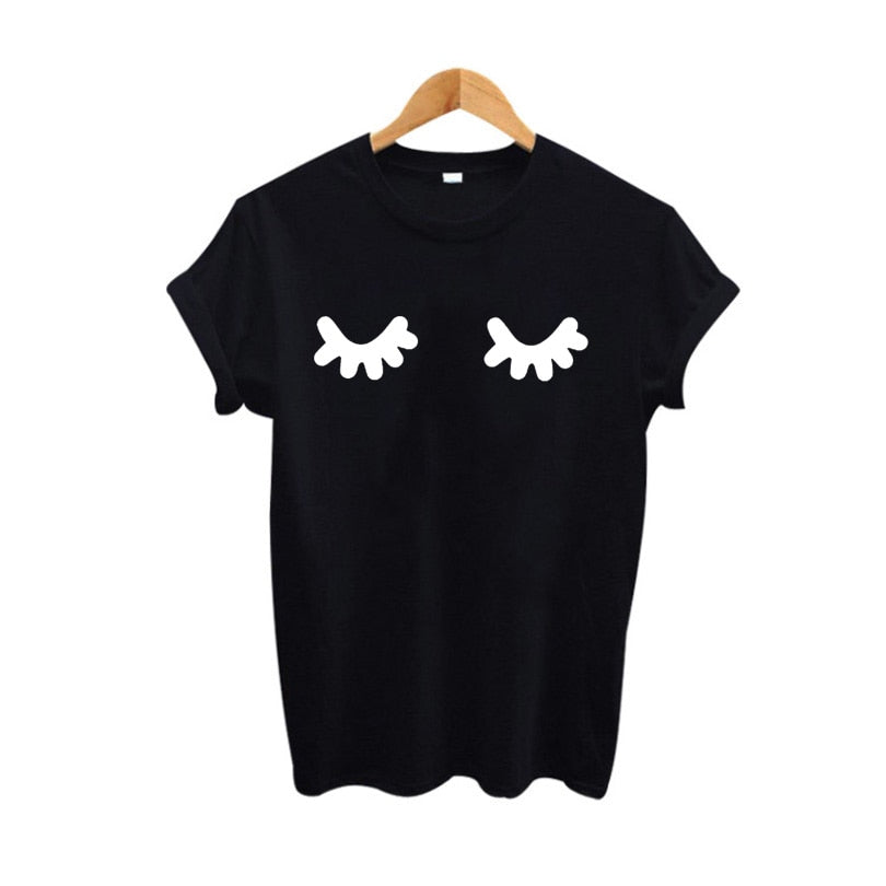 Women's playful eyelashes graphic print short sleeve crewneck t-shirt, available in black with white print and white with black print.