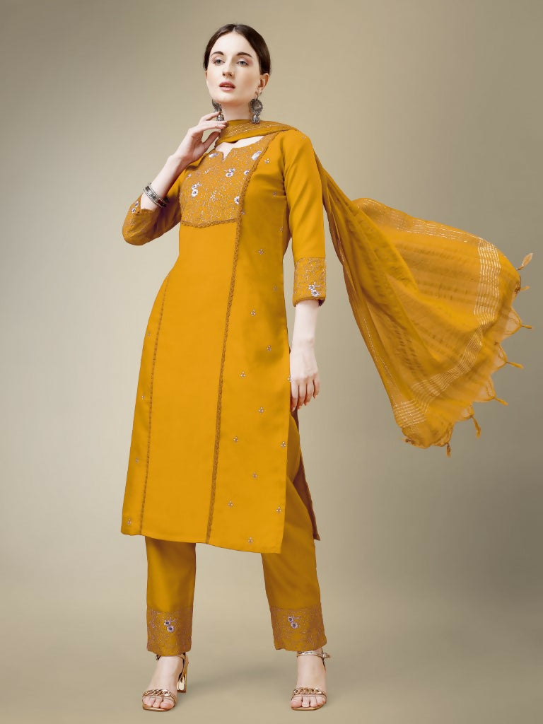 Women's yellow cotton blend straight kurta with embroidery and fancy lace work paired with trousers and a dupatta.