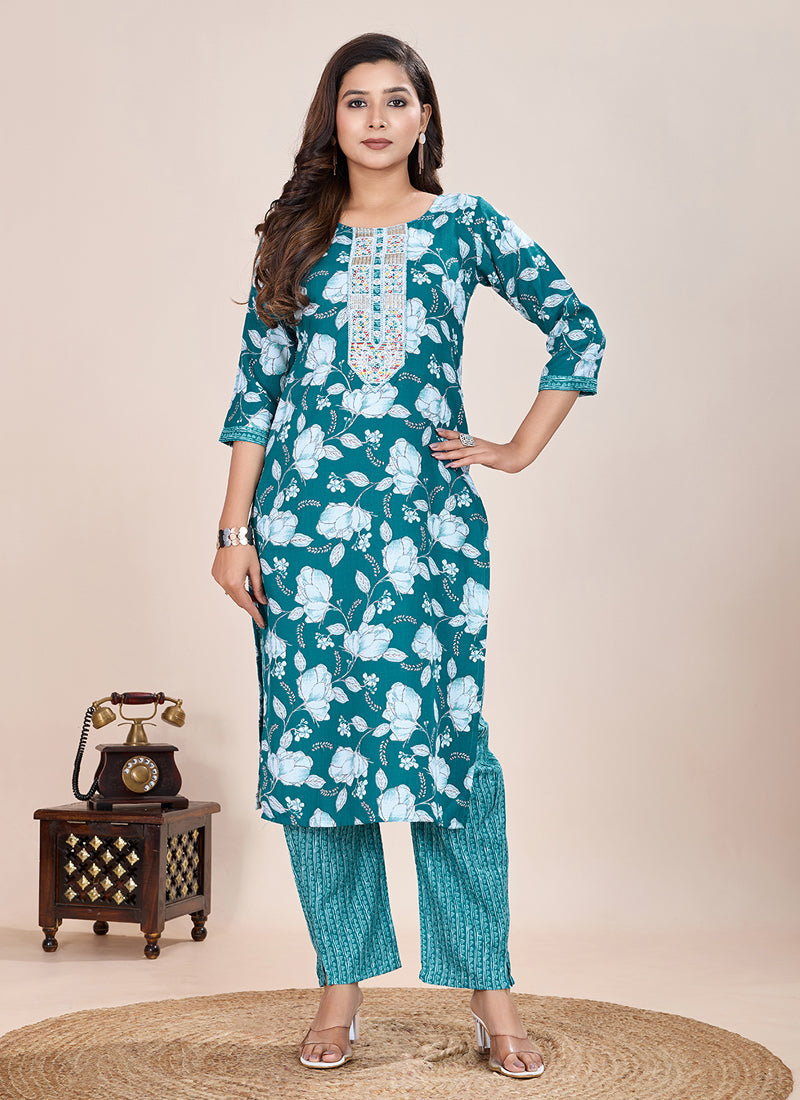 Model wearing a turquoise printed cotton blend kurta and matching pant set