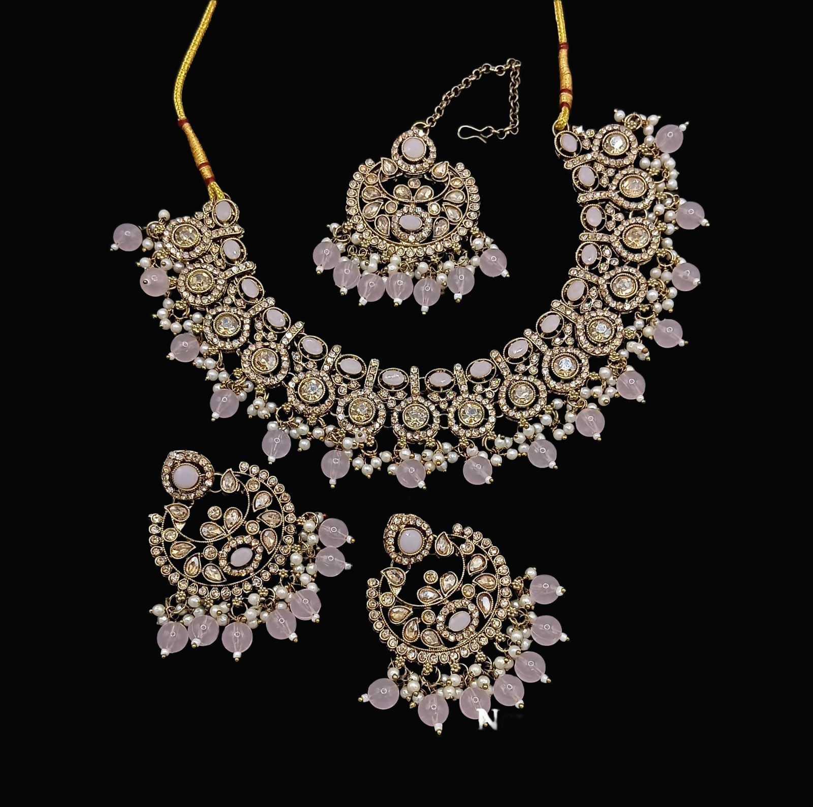Light peach stone work necklace set featuring a necklace, matching earrings, and maang tikka