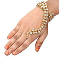 Gold polished brass Kundan Hathphool with crème details on a hand