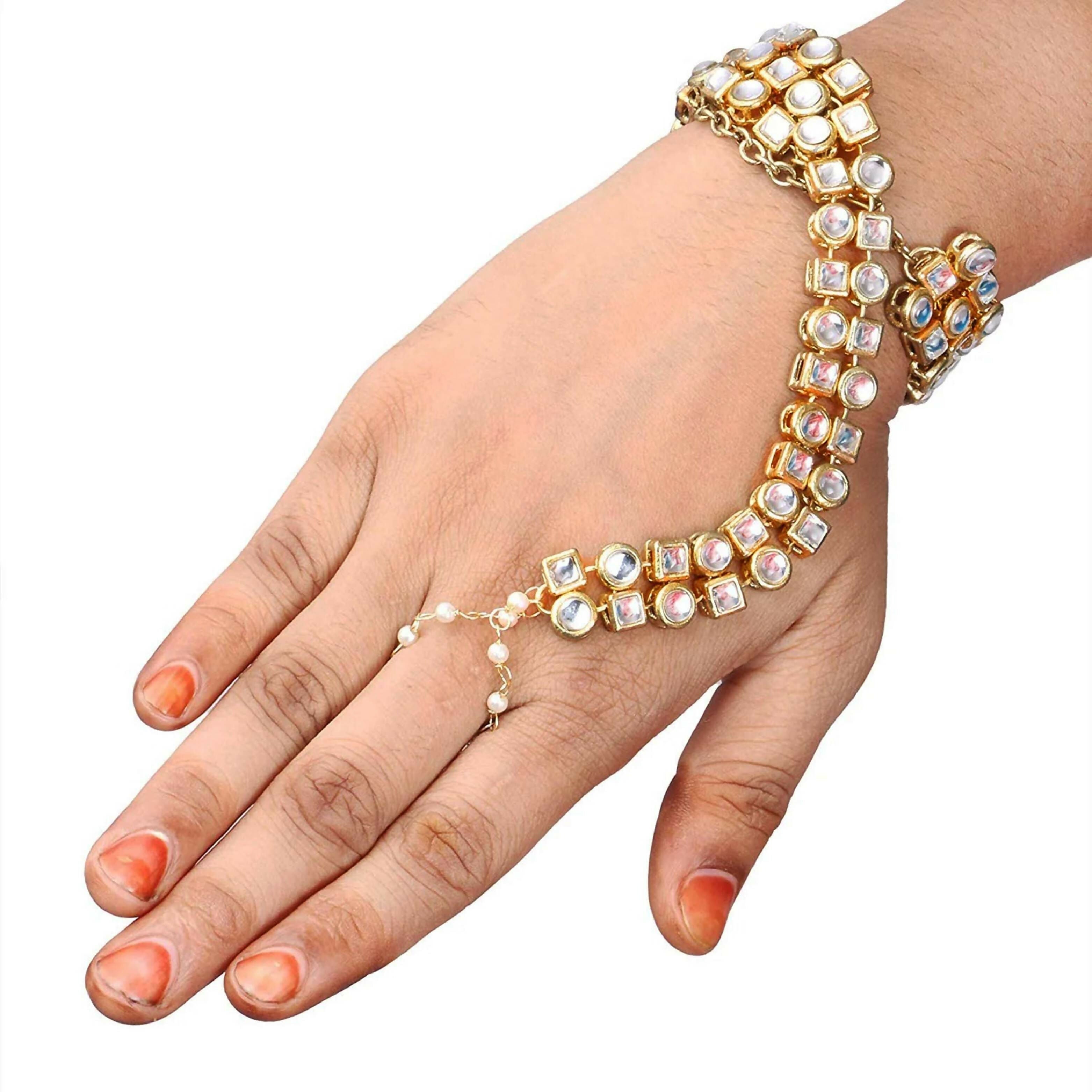 Gold polished brass Kundan Hathphool with crème details on a hand