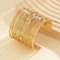 Stylish gold brass adjustable kada bracelet for girls in a polished finish