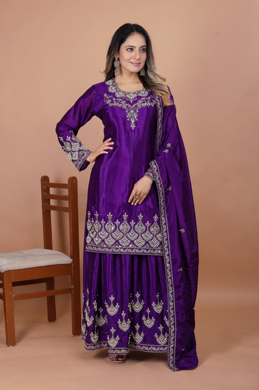 Model wearing a violet Chinon silk sharara suit with intricate embroidery and rivet moti work