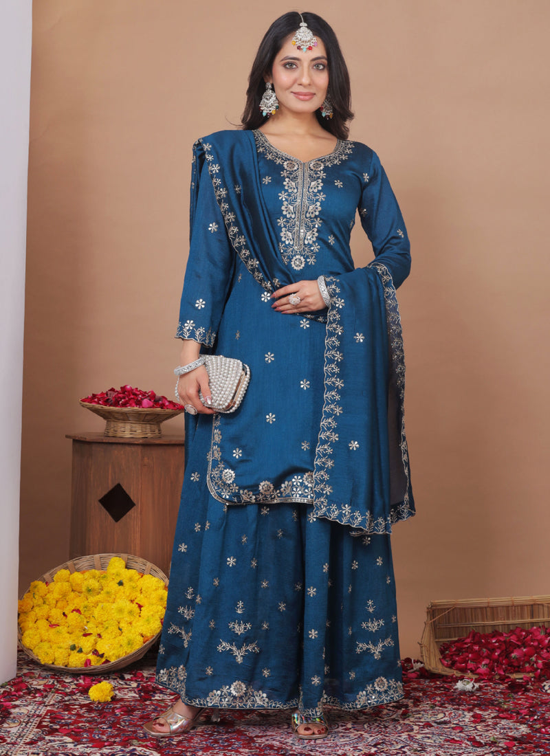 Model wearing a Royal Blue Vichitra silk sharara suit with intricate sequin and thread embroidery.