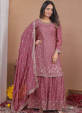 Model wearing an onion pink Chinon silk sharara suit with sequin and thread embroidery.