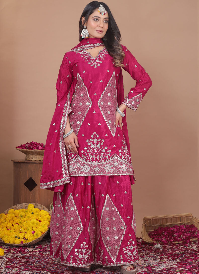 Front view of a pink chinon silk sharara suit with detailed sequin and thread work embroidery.