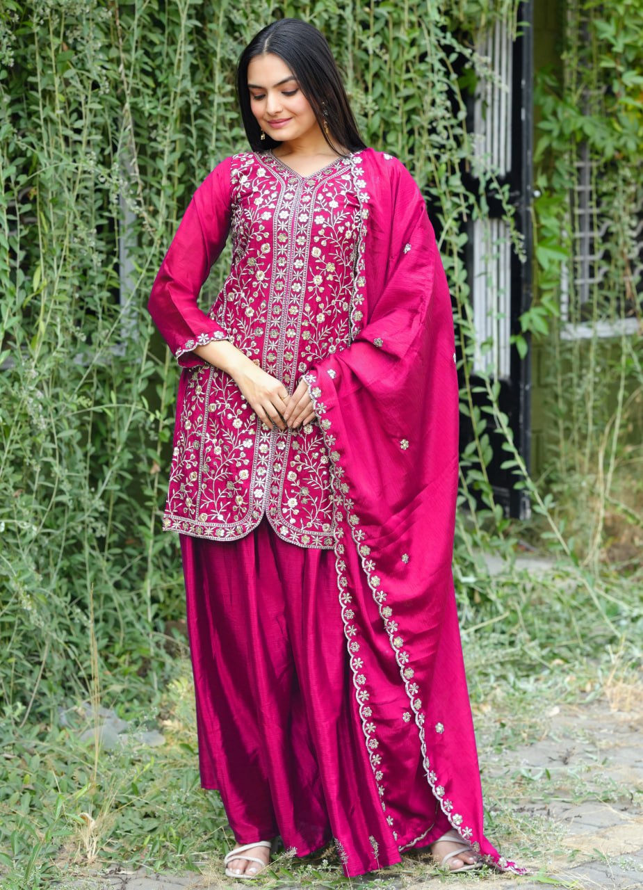 Woman wearing a pink Chinon silk sharara suit with heavy sequence embroidery and matching dupatta