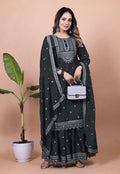 Model wearing a black Chinon silk sharara suit with heavy sequence embroidery