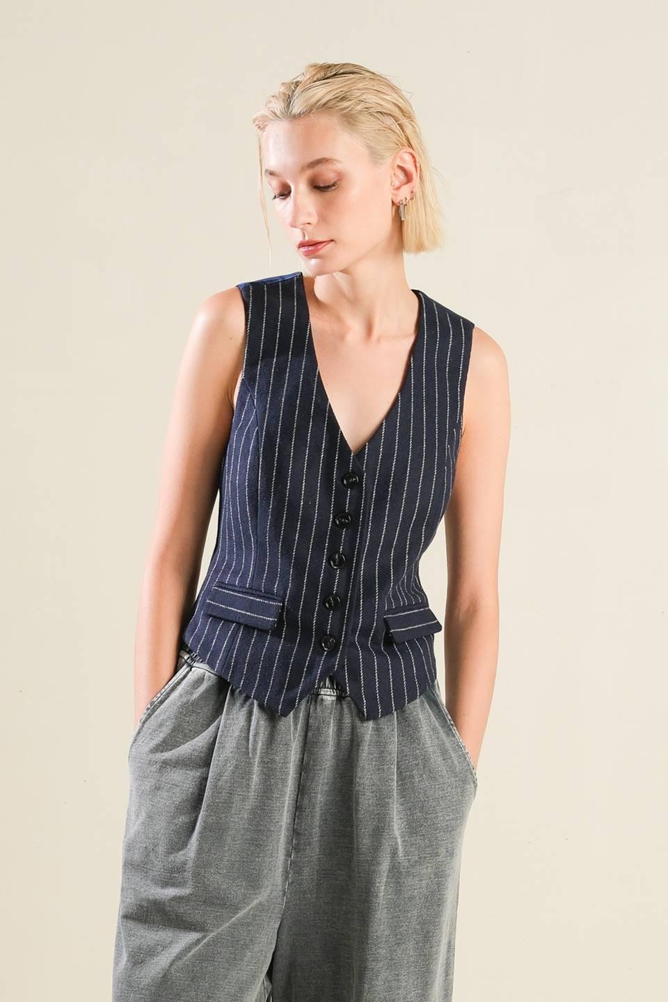 A front and back view of a navy blue pinstripe woven vest with front button closure on a model.