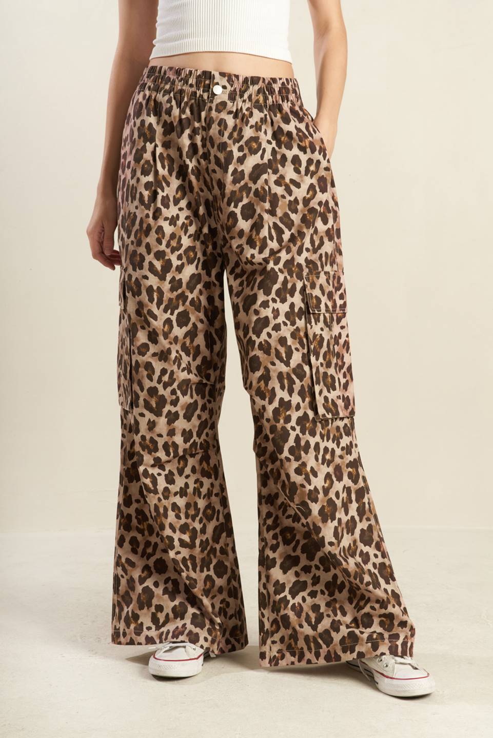 A pair of Flying Tomato leopard print wide-leg cargo pants worn by a model.