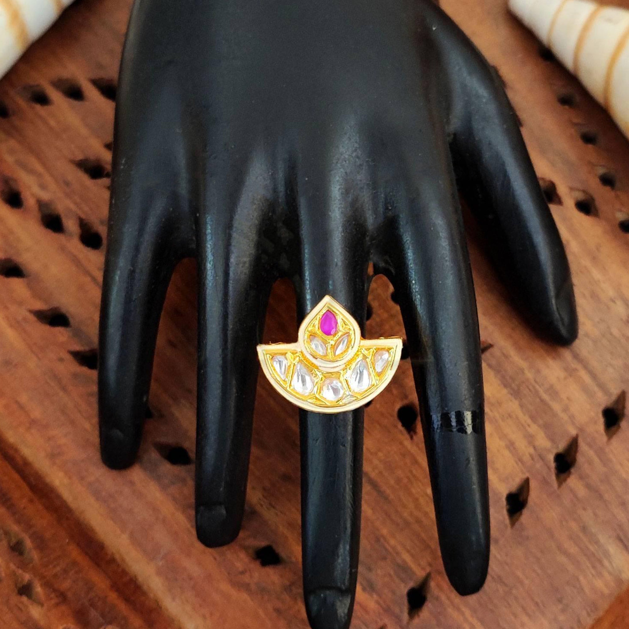 A decorative high gold polish Kundan ring for women with traditional Mughal-style stone settings.