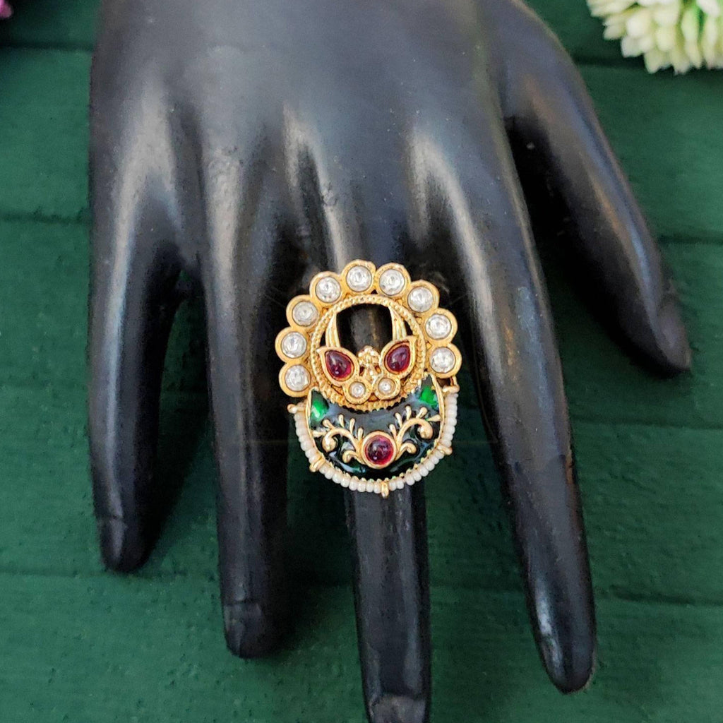 Close-up of designer high gold adjustable finger ring with multicolored gemstones for bridal and festive wear