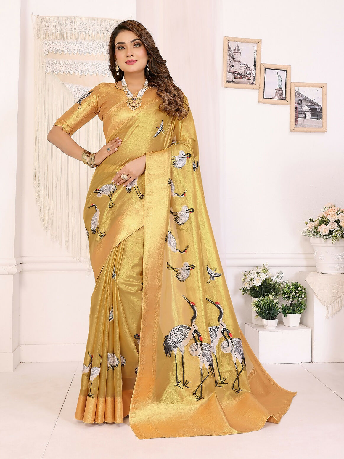 Golden Banarasi silk saree featuring crane patterns and soft tissue fabric