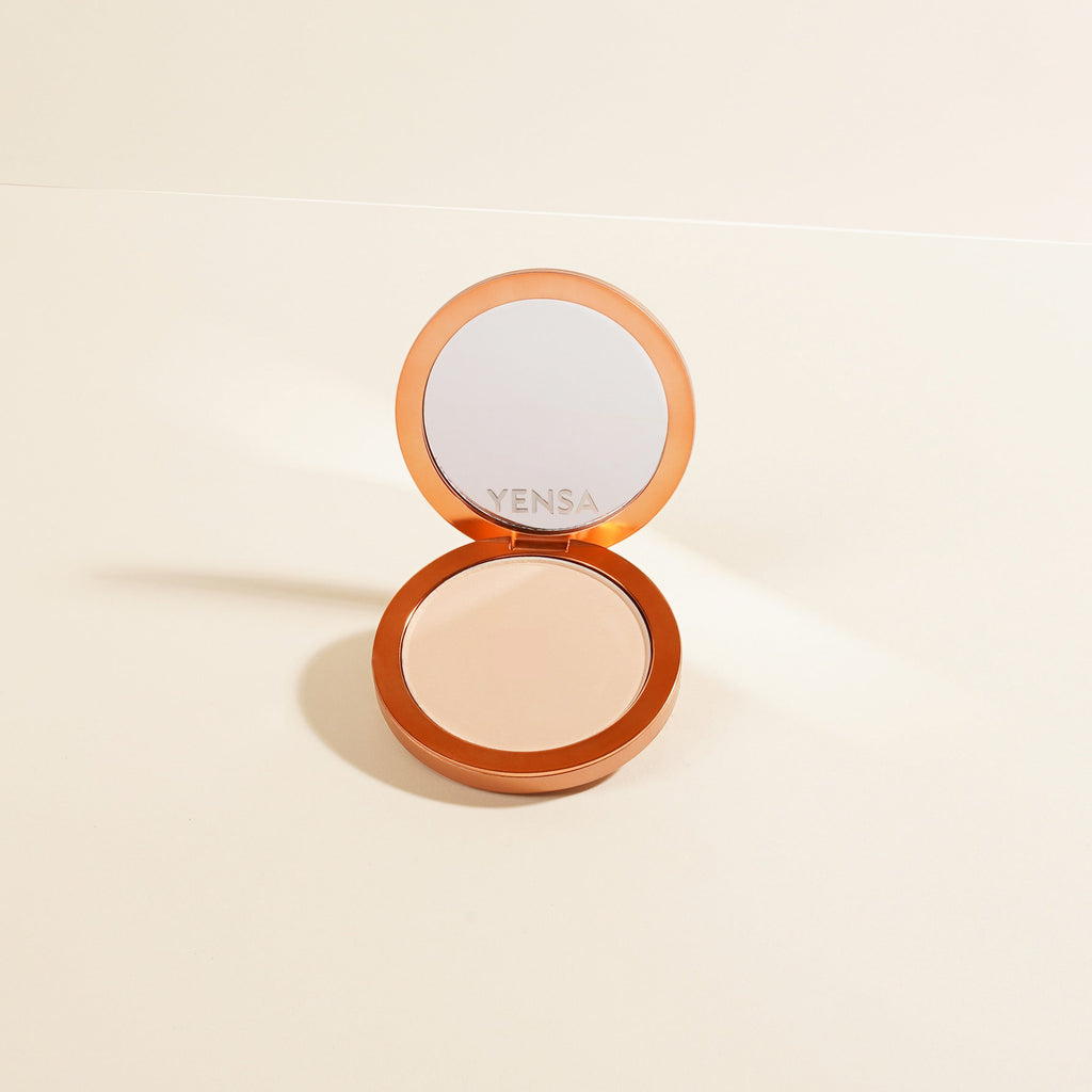 Open compact of Yensa Super Serum Silk Matte Powder Foundation showing a mirror and beige powder finish.