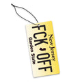 Yellow license plate style FCK-OFF novelty car air freshener hanging in a vehicle