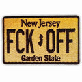 Close up of a rectangular FCK OFF license plate patch with an iron-on backing