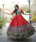 Red Dola silk Anarkali dress featuring traditional Patola patterns and foil print